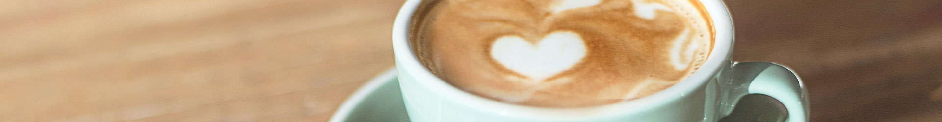 Latte-Art-Herz Cappuccino in hellblauer Kaffeetasse